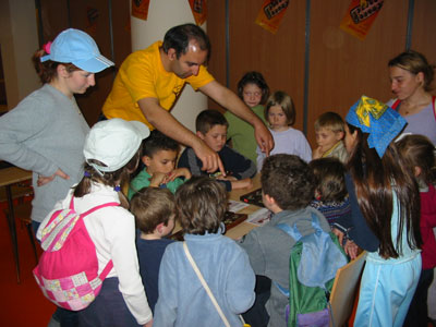 Guy Sepahi showing children how to play Awele
