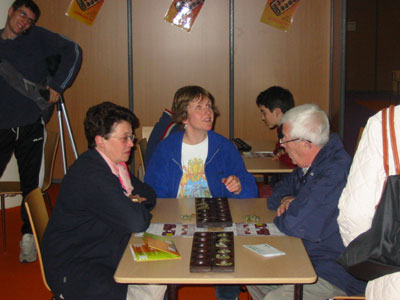 Erin tutoring an elderly couple how to play Awele 