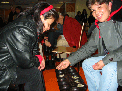 Sungka players from Malaysia having a game.