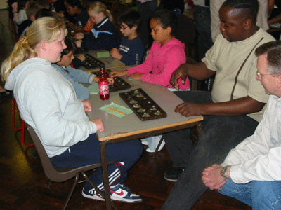 Community Initiatives staff member having a game with players.