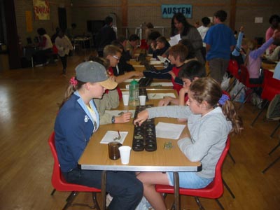 A shot of players with Judith Caton taking score cards