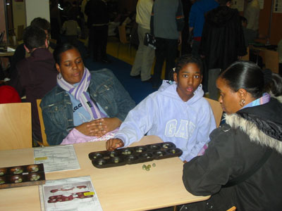 Renissa having a game with her aunt with mum watching on.