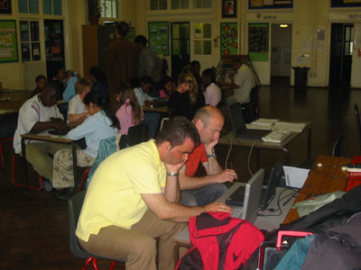 Teacher & Parent playing Oware on the computer. 