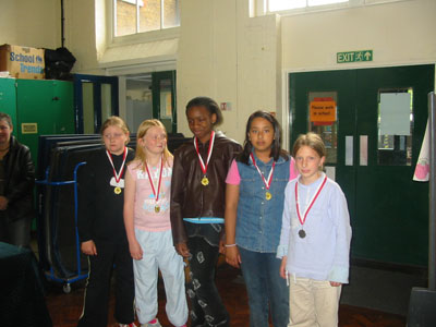 Group picture of the British School of the Netherlands Team 2 receiving with their cups.