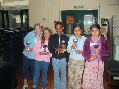 Group picture of the British School of the Netherlands Team 1 receiving with their cups.