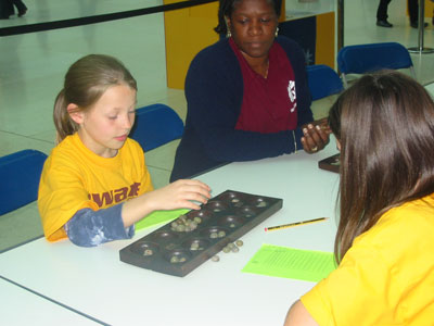 Phoebe Ballantyne-Brown & Maguerite Frisby having a game with Glenda Trew looking on. 