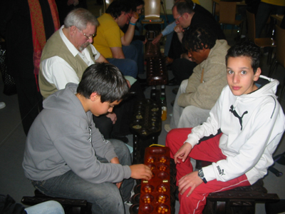 Fernando playing George with junior players in the foreground.